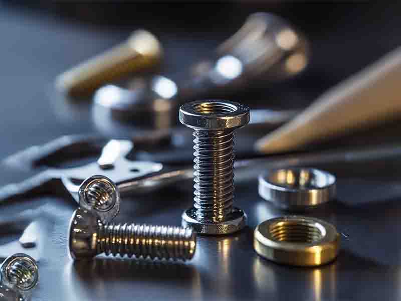 Close-up of high-precision custom screws in stainless steel, carbon steel, and brass, highlighting their intricate threads and durable construction for diverse industrial applications.