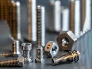 Close-up of custom screws showcasing both metric and imperial thread specifications, including ISO Metric and Unified Thread Standard (UTS), highlighting their fine details, precision, and versatility for various industrial applications.